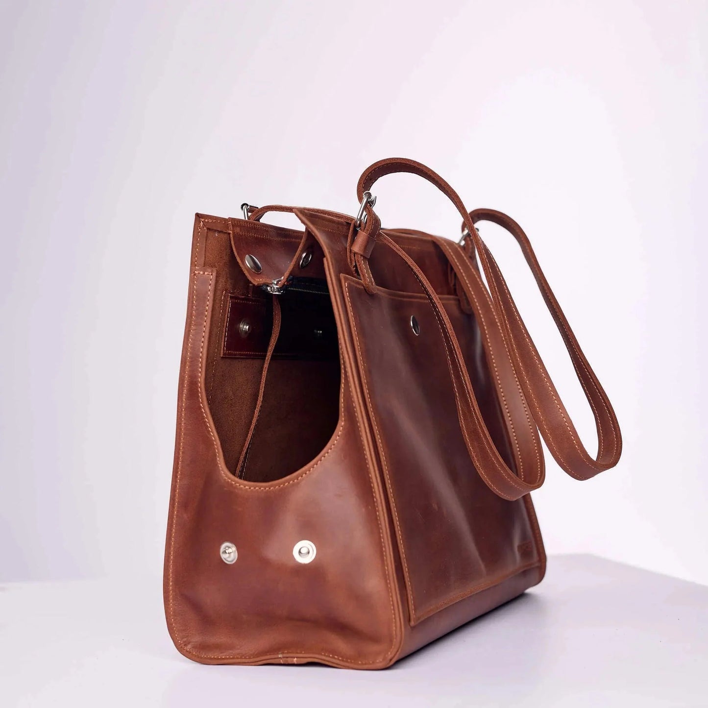 Brown leather dog carrier with adjustable shoulder straps - genuine leather construction
