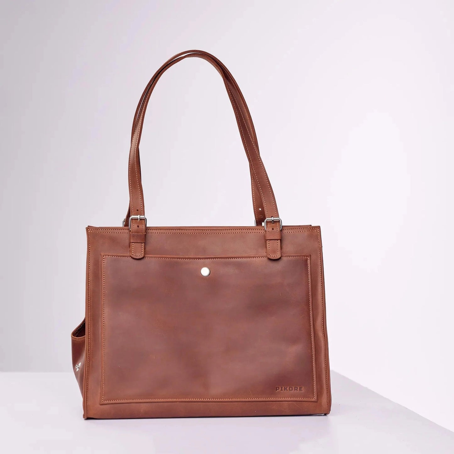 Green leather dog carrier detail - durable construction with comfortable carrying handles
