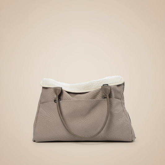 Premium dog tote carrier bag in beige with small dog inside, showing front view with multiple pockets and comfortable handles